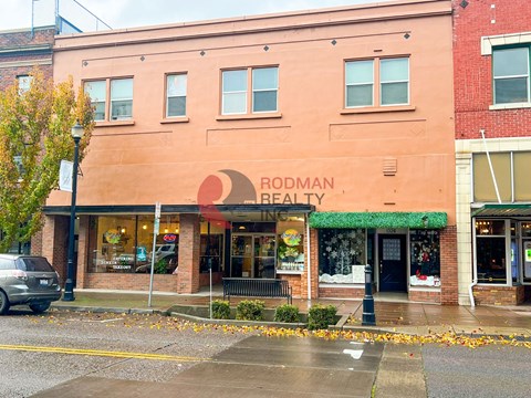 Rodman Realty is a brick building with a green awning.