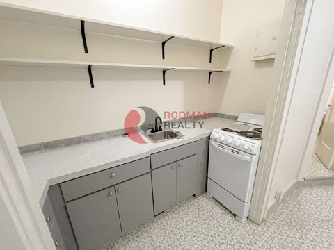 A small kitchen with a stove and a sink.