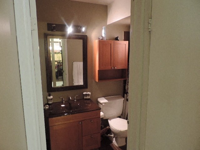 a bathroom with a toilet and a sink and a mirror