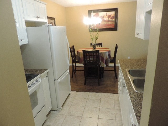 a kitchen with white appliances and a dining table