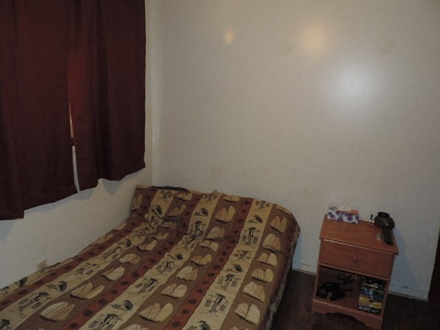 a small bedroom with a bed and a table