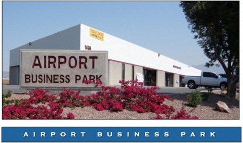 A white building with a sign that says Airport Business Park.
