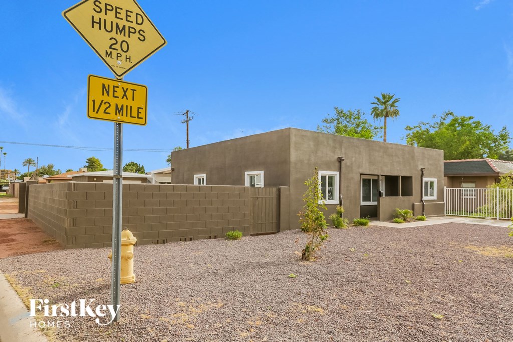A yellow sign warns of speed humps ahead.