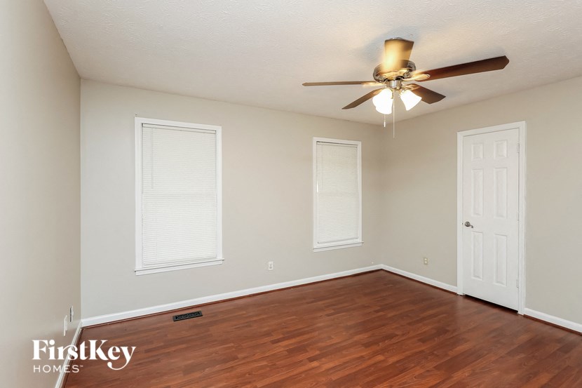 a living room with a wood floor and a ceiling fan
