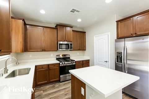 A kitchen with wooden cabinets and stainless steel appliances.