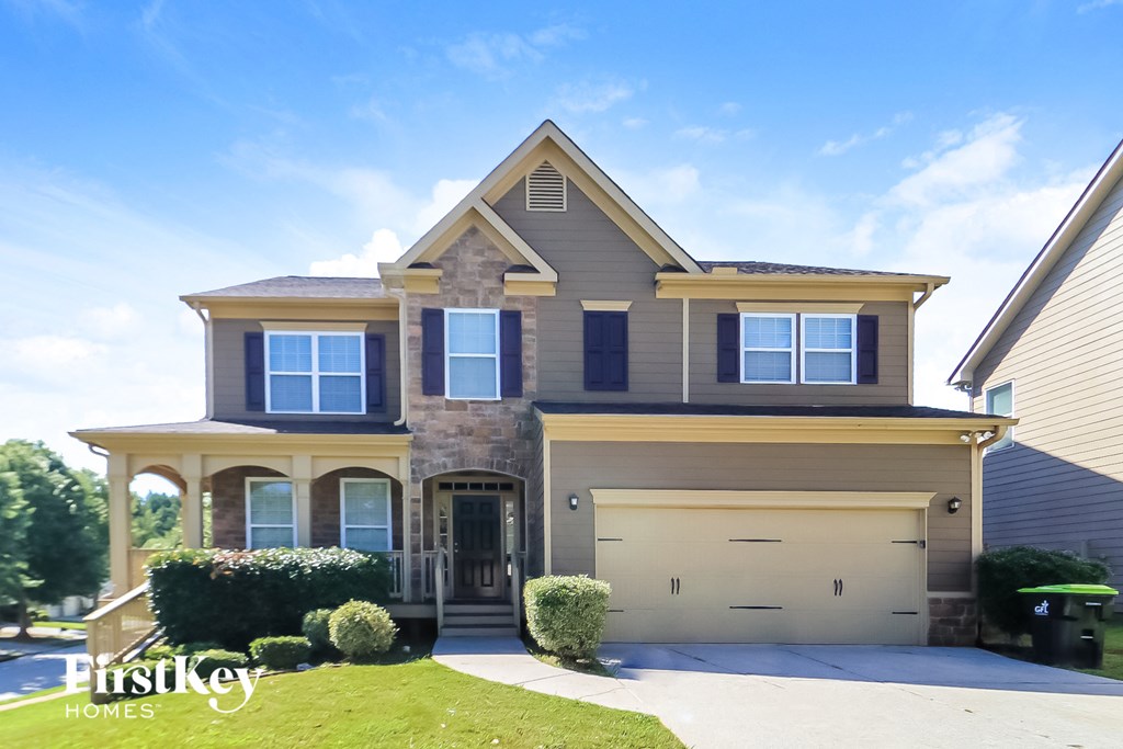 a house with a garage door and a lawn