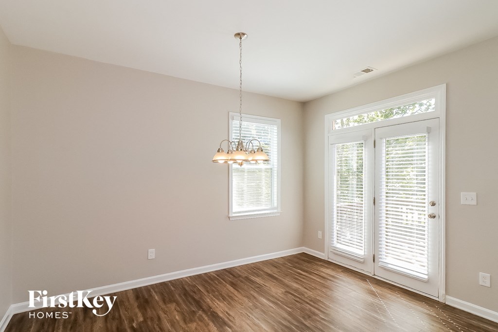 a living room with wood floors and a chandelier