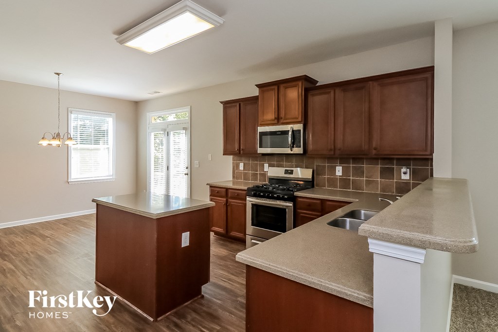 an open kitchen with wooden cabinets and granite counter tops