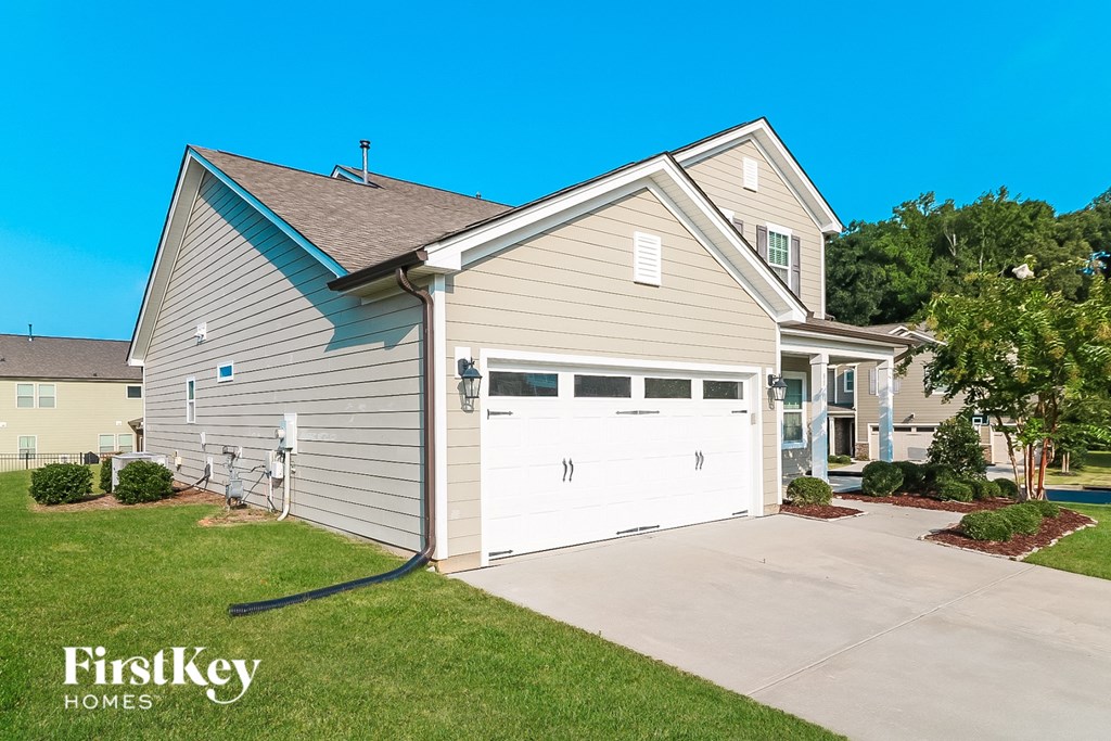 a home with a white garage door and a driveway