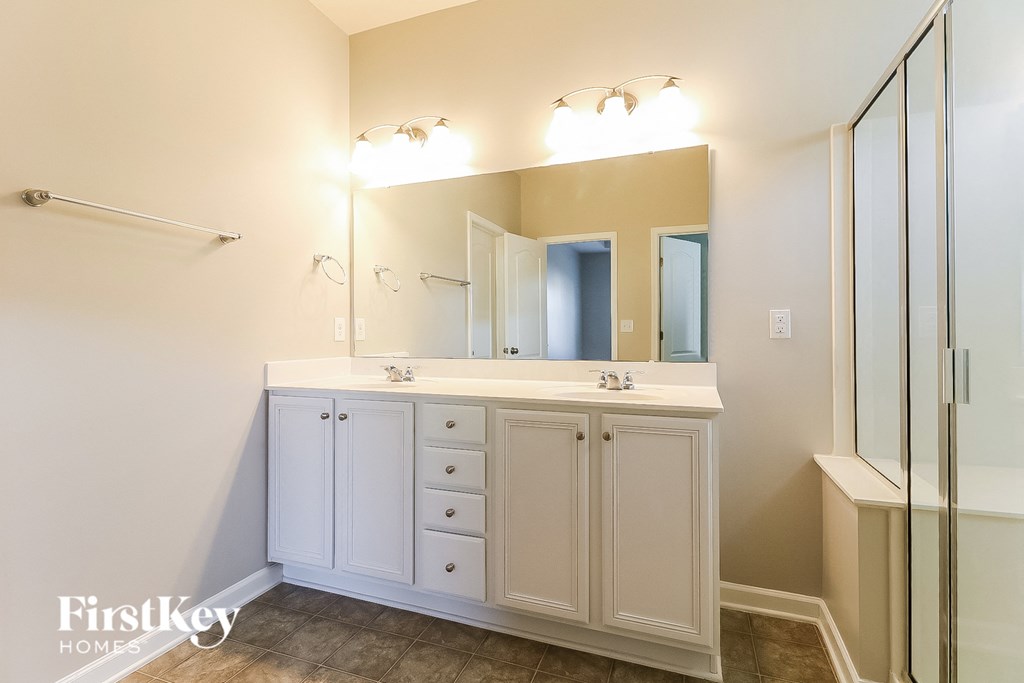 a bathroom with a sink and a mirror and a shower