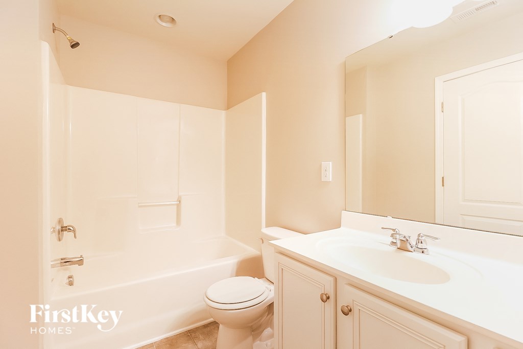 a bathroom with a sink toilet and a tub