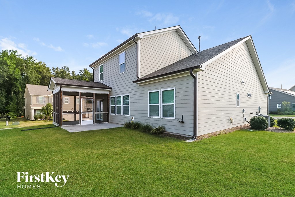 a white house with a grassy yard and a garage
