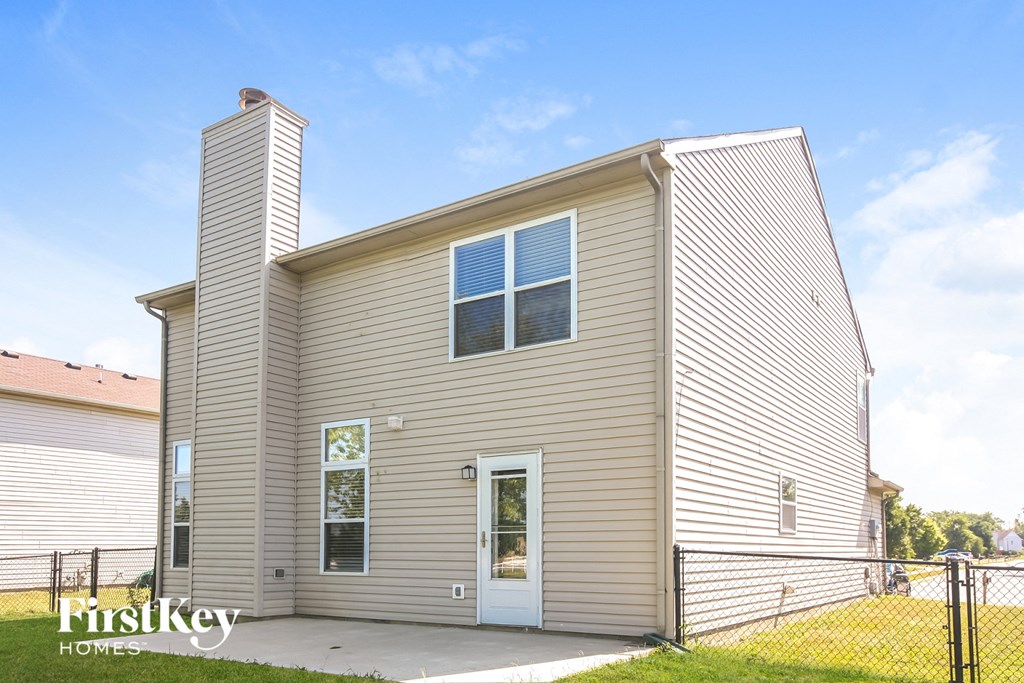 the outside of a house with a fenced in yard