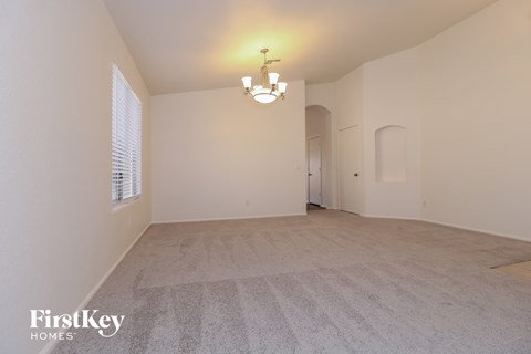 the living room and dining room of an empty house