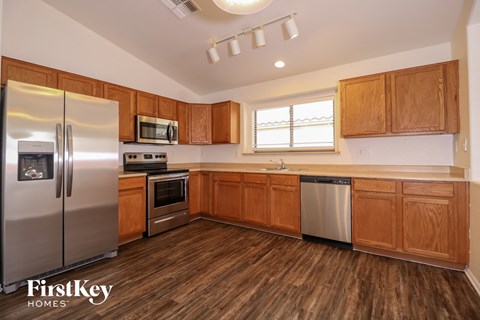 a kitchen with wooden cabinets and stainless steel appliances