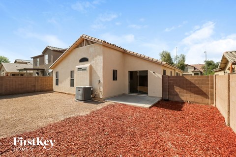 a house with a driveway and red gravel