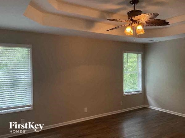 a living room with a ceiling fan and a window