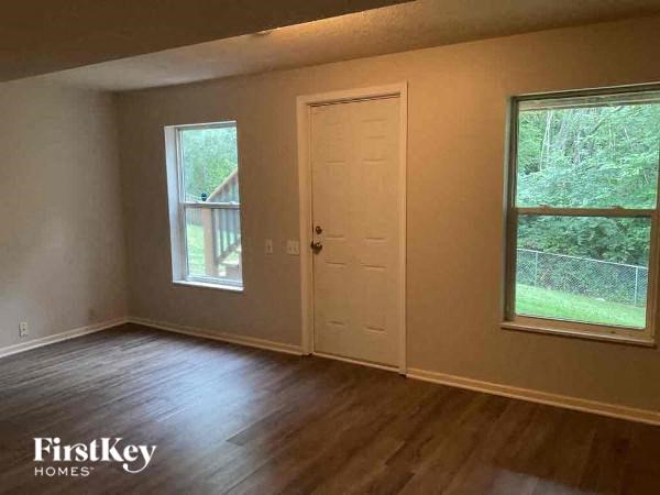 an empty room with a door and a window