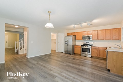 A kitchen with wooden cabinets and a stainless steel refrigerator.