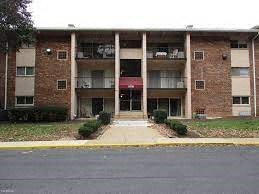 A brick building with a red awning in front.