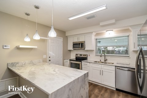 a kitchen with marble counter tops and stainless steel appliances