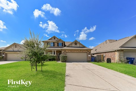 a large house with a driveway and a lawn
