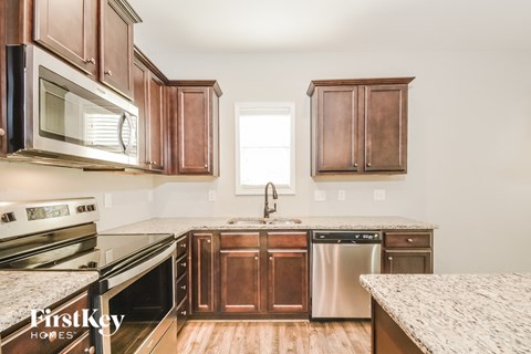 A kitchen with wooden cabinets and stainless steel appliances.
