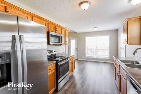 a kitchen with stainless steel appliances and wooden cabinets