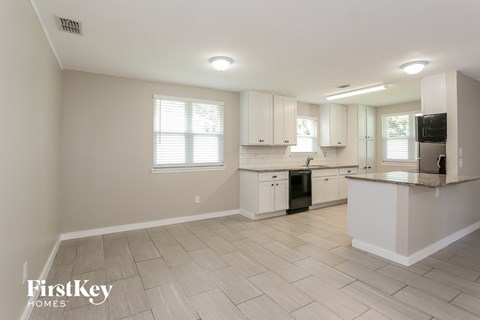 a large kitchen with white cabinets and a counter top