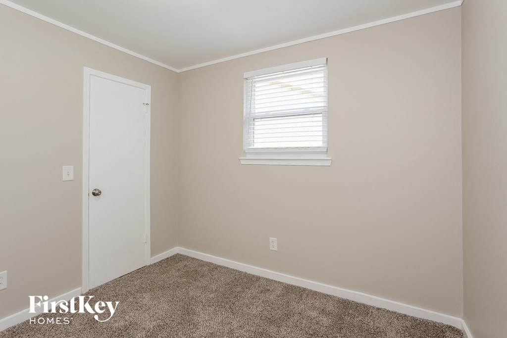 a bedroom with a white door and a window