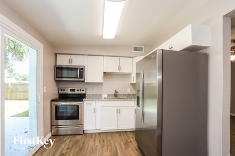 a kitchen with stainless steel appliances and white cabinets