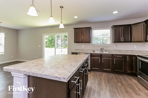 a kitchen with a large island and dark wood cabinets