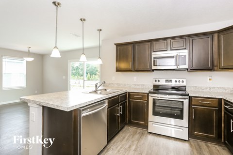 A kitchen with a stove top oven and a dishwasher.