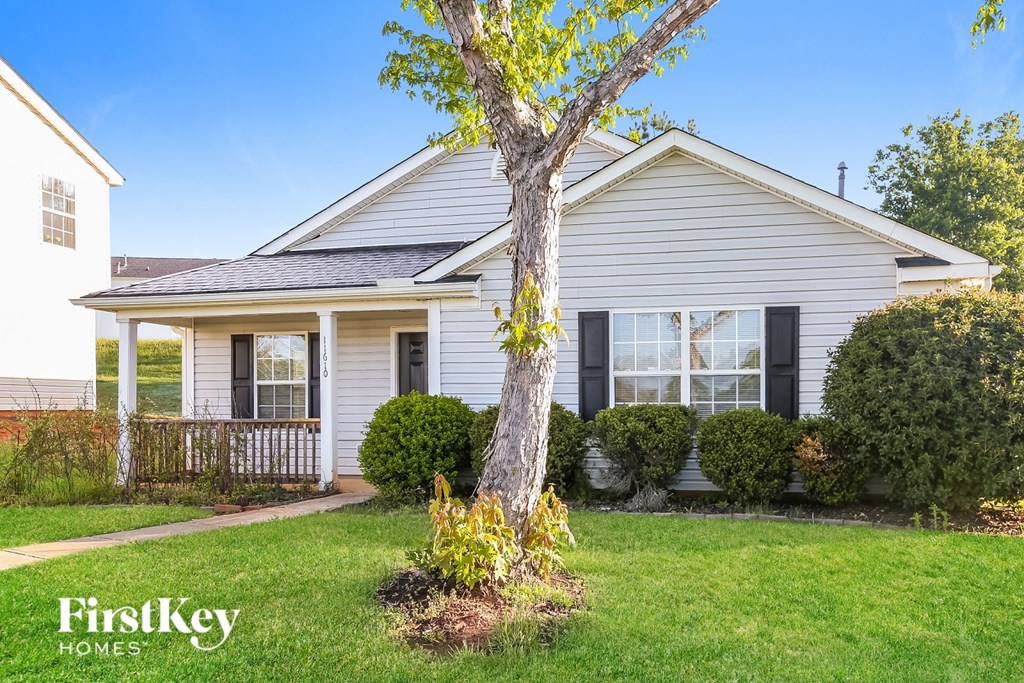 A house with a tree in front of it.