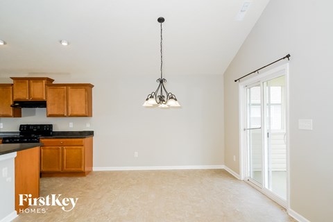 A kitchen with wooden cabinets and a black countertop.