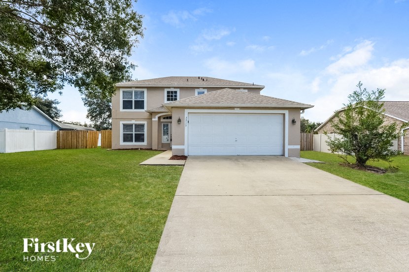 a house with a driveway and a white garage door