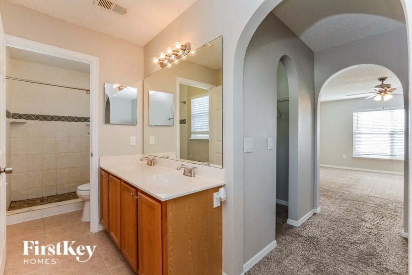 a bathroom with a large mirror and a sink