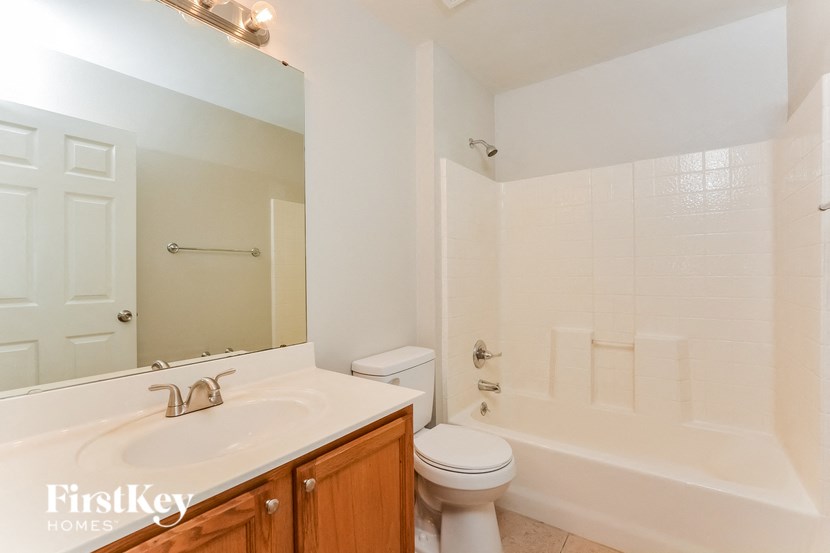 a bathroom with a sink toilet and a bath tub