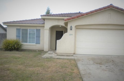 a house with a driveway and a garage door