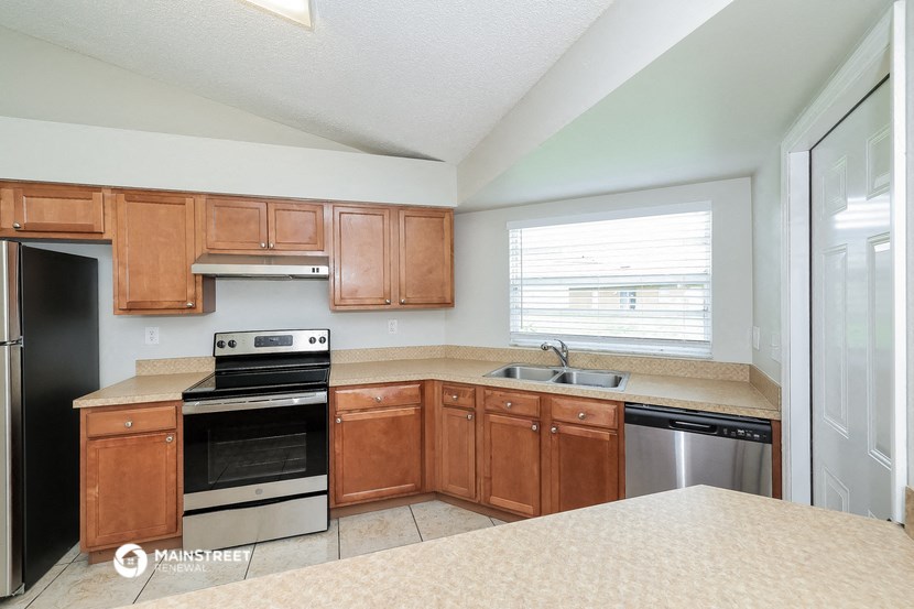 a kitchen with wooden cabinets and black appliances