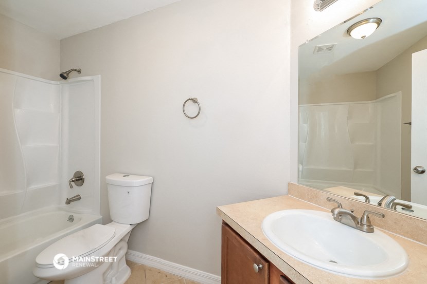 a bathroom with a sink and a shower and a toilet