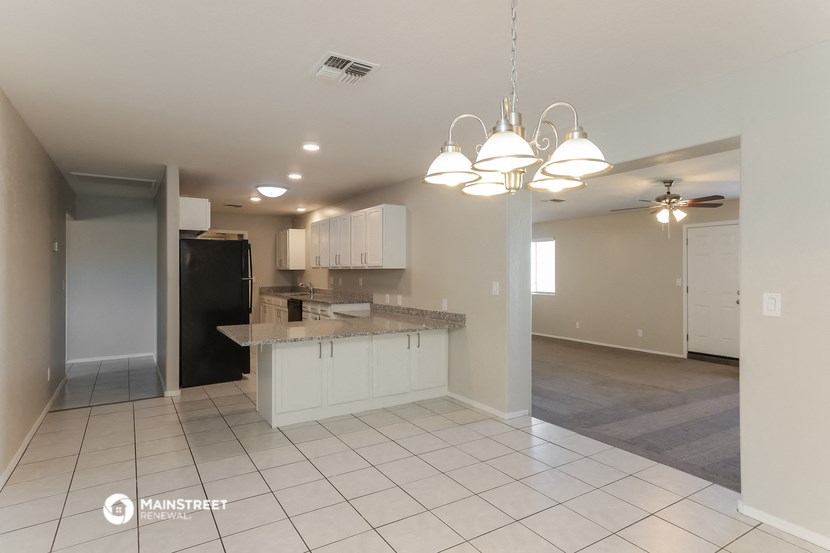 a kitchen with an island in the middle of a living room