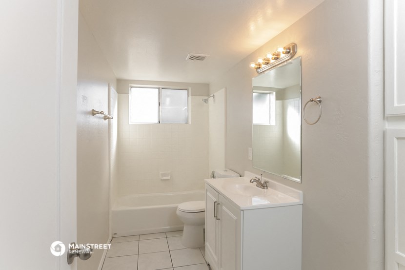 a bathroom with a sink and a toilet and a mirror