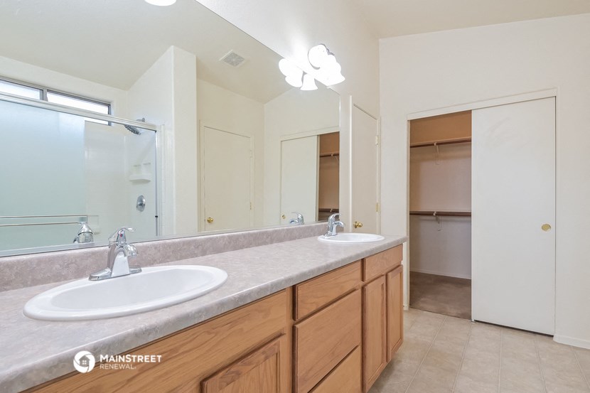 a bathroom with two sinks and a large mirror