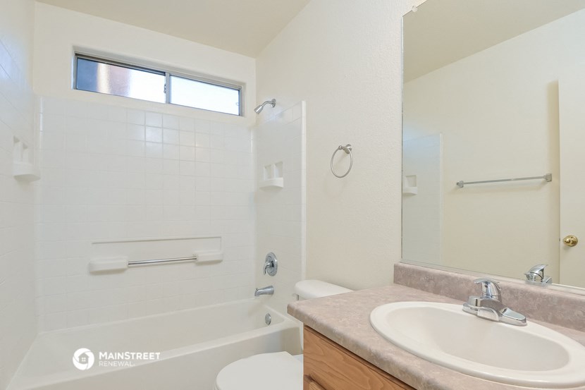 a bathroom with a sink and a shower and a toilet