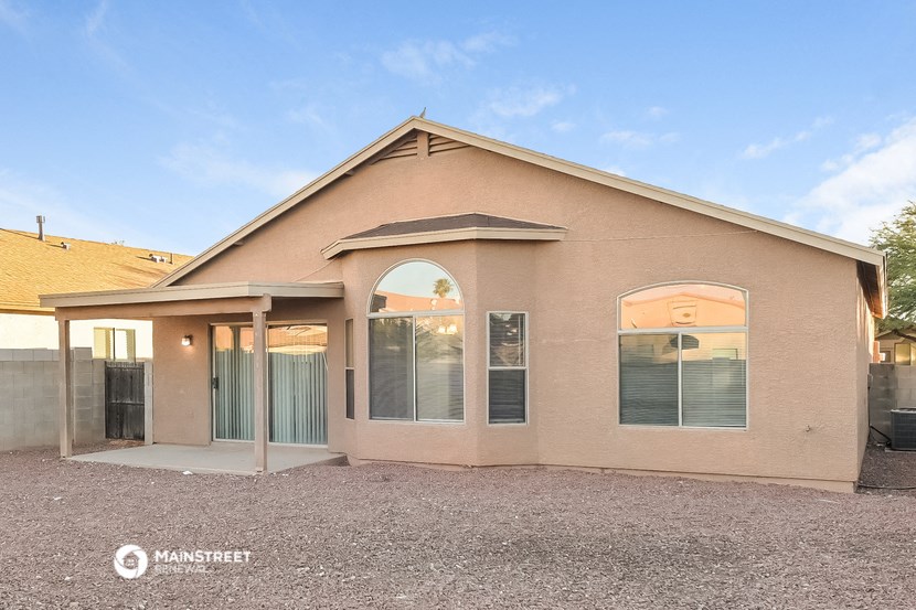 the outside of a house with glass doors and a roof