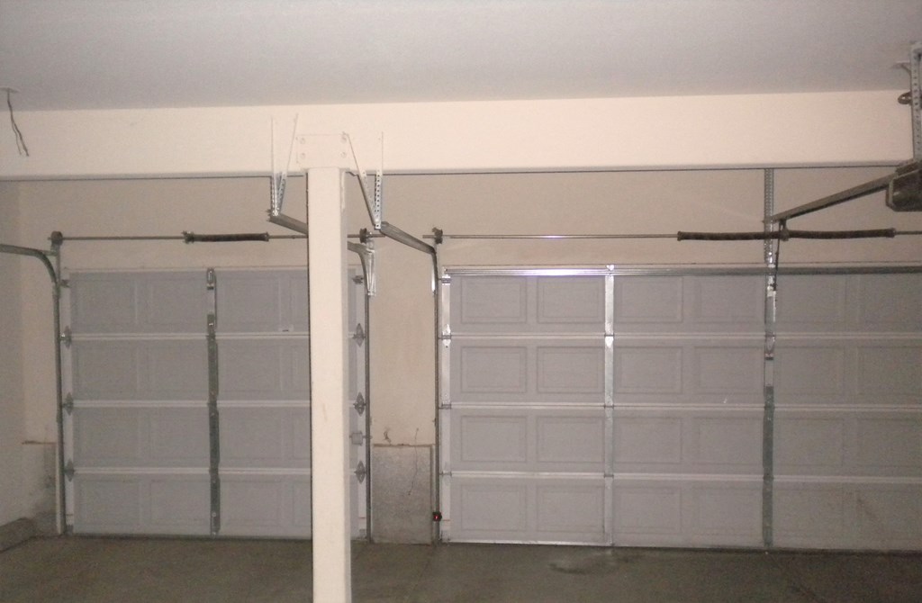 a garage with white walls and white garage doors