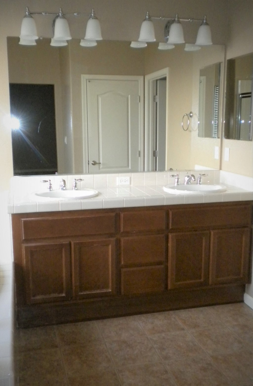 a bathroom with two sinks and a large mirror