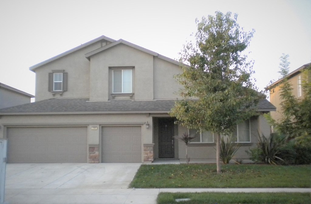 a house with a driveway and a garage door