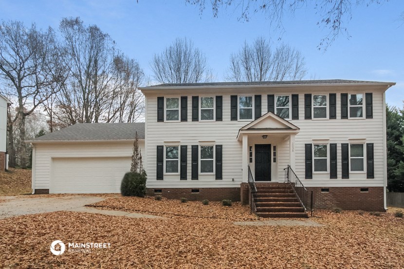 a white house with black shutters and a front porch